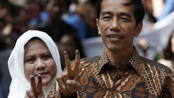 Indonesian presidential candidate Joko "Jokowi" Widodo and his wife Iriana after casting their vote in Jakarta on Wednesday. Photo: Reuters/Darren Whiteside