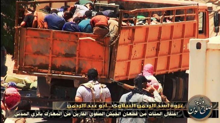 ISIL prisoners are packed into a truck and driven away. Photo: Twitter
