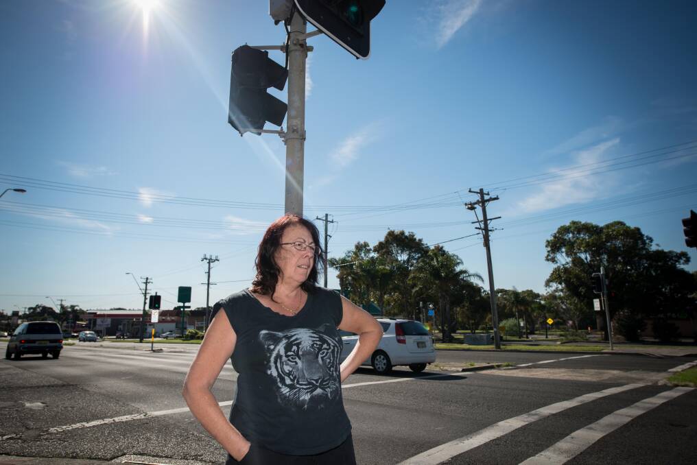 Warilla resident Rhonda Tully believes something needs to be done to reduce the danger for drivers and pedestrians at the intersection of Queen Street and Shellharbour Road in Warilla. Picture: ALBERT BOND