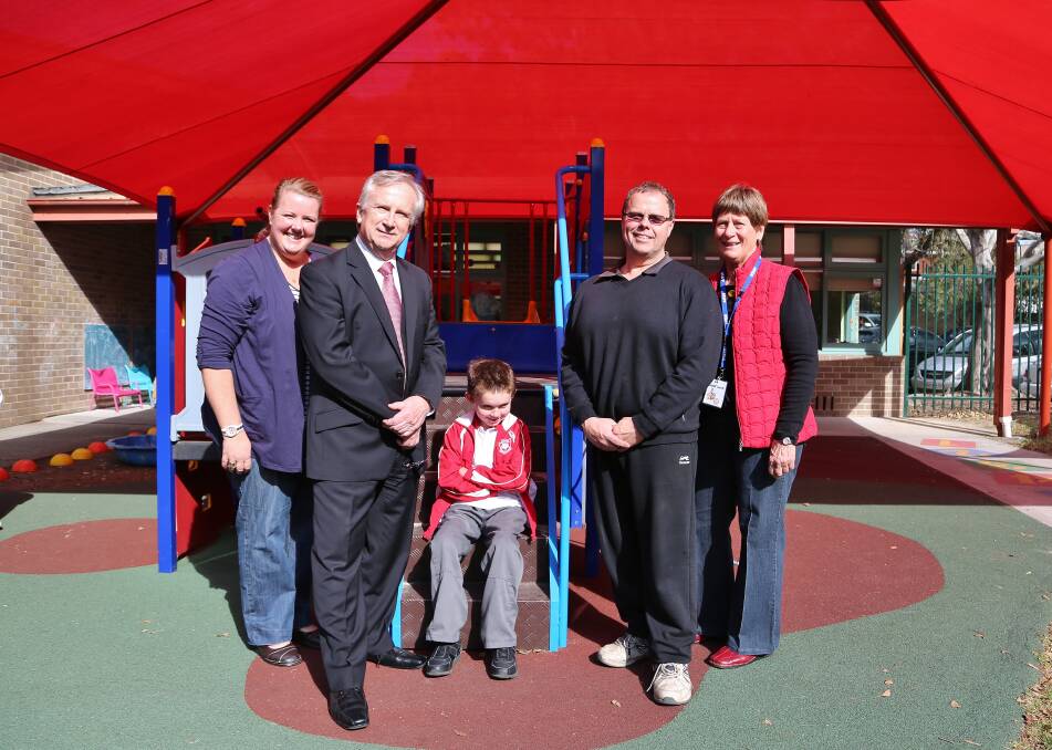 Renae Burton, Bob Kotic, Grant Burton, Glen Payne and Ruth Kilah check out the new shade sail over the  softfall area  at Figtree Primary School. Picture: GREG ELLIS