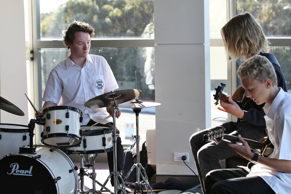 Clint Corbin plays the drums with a group of fellow students. He has won a music scholarship from the IMB, which will pay for professional tutelage for a year. Picture: GREG ELLIS
