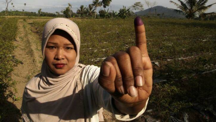 I've voted: a woman in Brambang Darussalam, Bondowoso, East Java, after voting on Wednesday. Photo: Reuters/Sigit Pamungkas