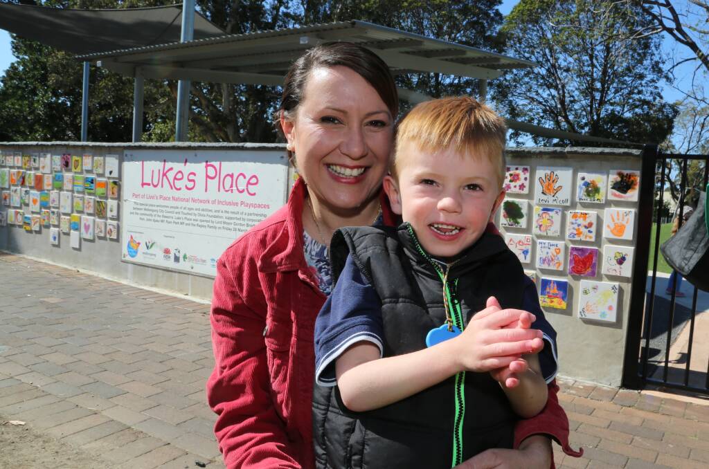 Rita Rapley, holding her son Luke, was named 2014 Corrimal citizen of the year along with her husband Sean. Picture: GREG ELLIS