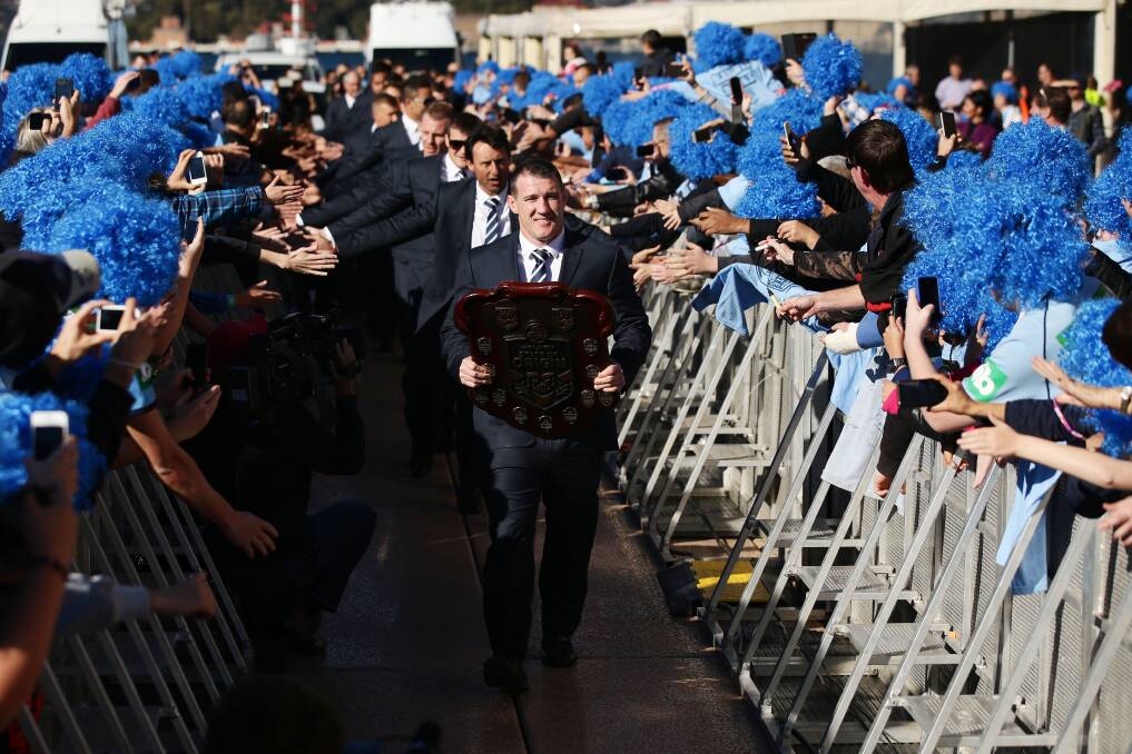 Paul Gallen leads out the NSW team with the State of Origin shield. Picture: GETTY IMAGES