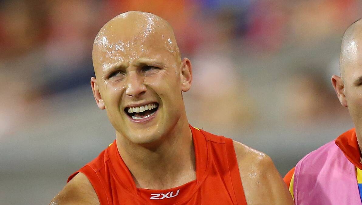 Gary Ablett leaves the field in pain during the game against Collingwood. Picture: GETTY IMAGES