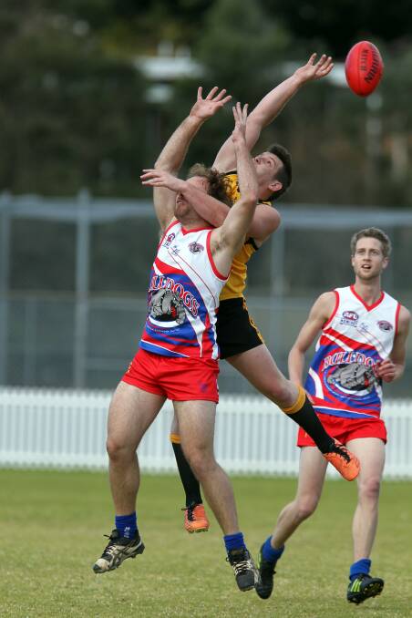 Northern Districts's Jared Wilson spoils in a marking contest with Wollongong's Justin Smith (front) in last weekend's South Coast AFL clash. Wollongong are away to Figtree in round 14.