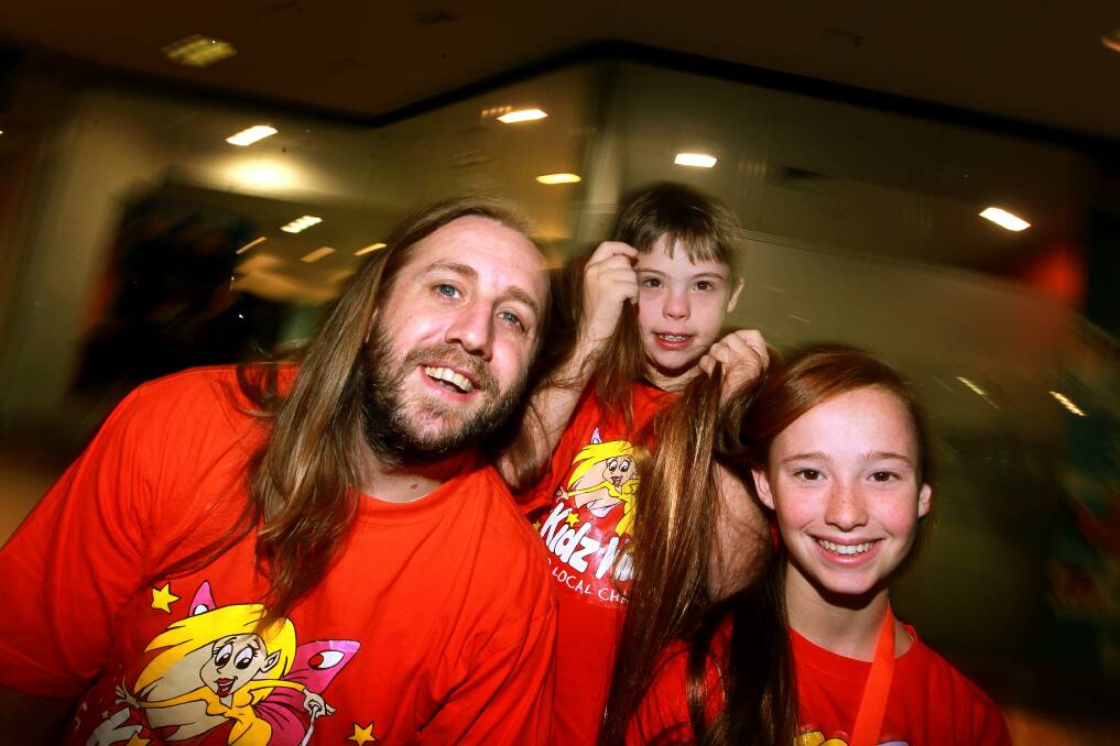 Jon Kellyevans with Caleb and Sophie Jordan. Jon and Sophie cut their hair to support Kidzwish. Picture: Sylvia Liber