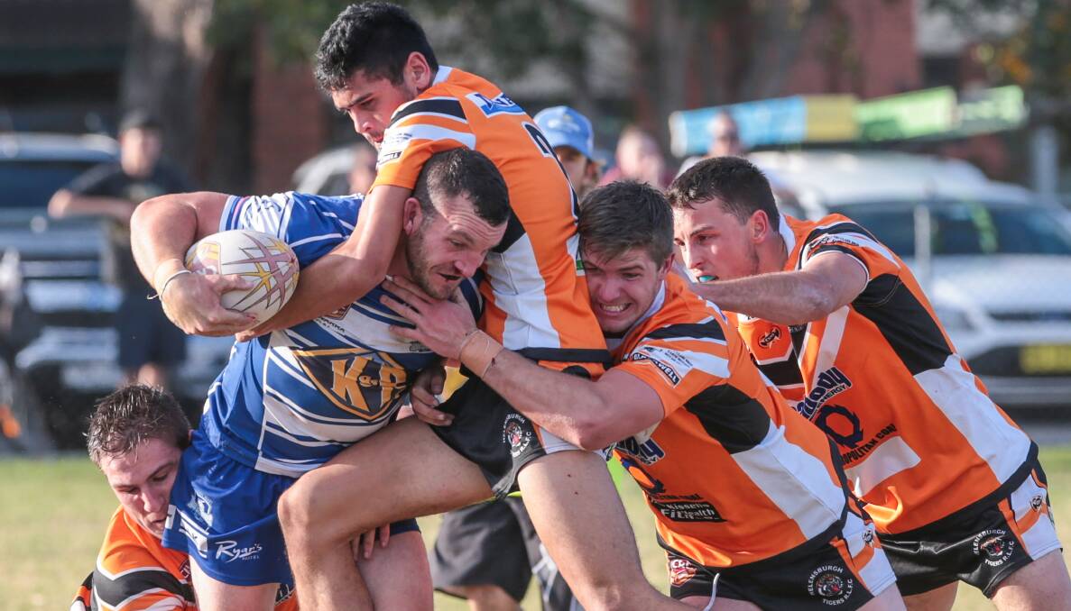 Thirroul's James Banister is brought down by the Tigers defence at Gibson Park. Picture: ADAM McLEAN