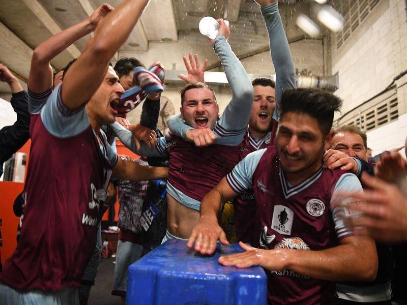 Jubilant APIA Leichhardt players celebrate their stunning FFA Cup win against Melbourne Victory.