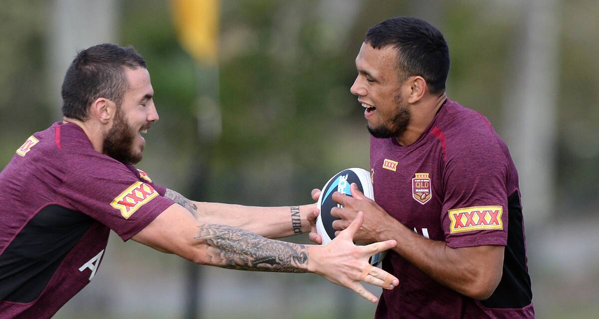 Rookie winger Will Chambers tries to evade Darius Boyd at a Queensland training session on the Gold Coast. Picture: GETTY IMAGES