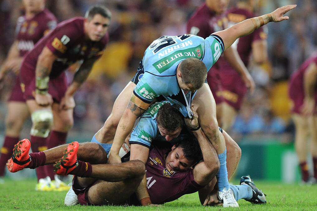 The Blues defence swarms over Justin Hodges at Suncorp Stadium on Wednesday. Picture: GETTY IMAGES