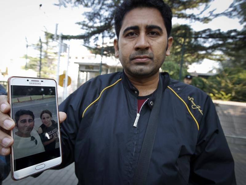 Mirza Imran Baig shows a picture of his Uighur wife, who was sent to a re-education camp.