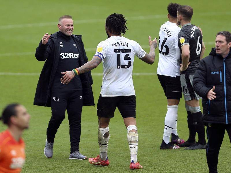 Wayne Rooney celebrates with Colin Kazim-Richards (13) after Derby avoided Championship relegation.