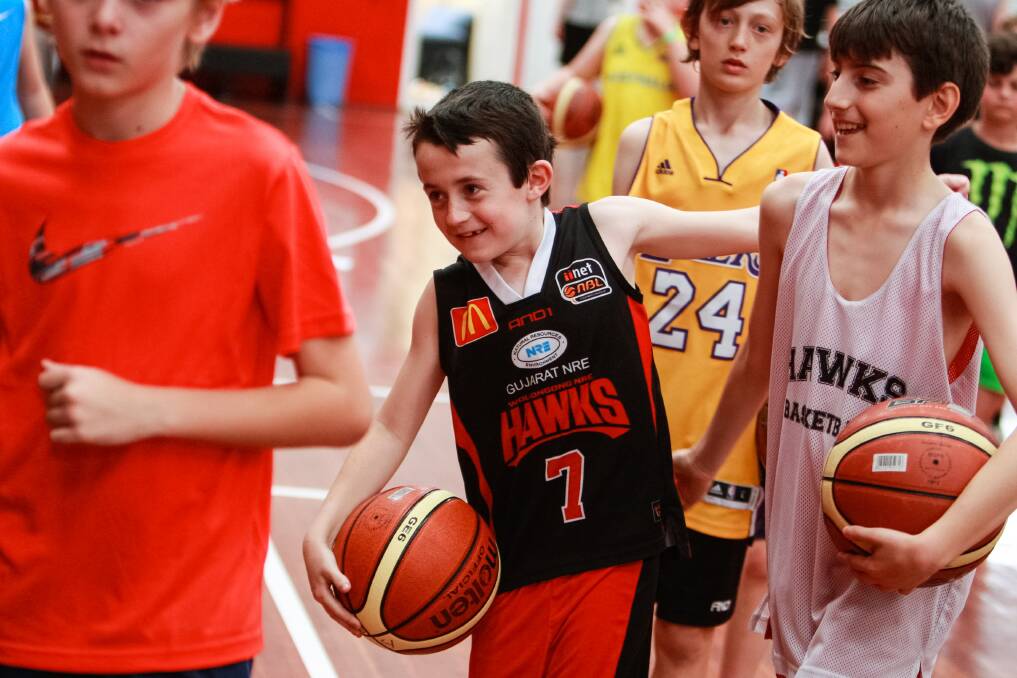 All smiles: Jackson Paulic (centre) was among the 70 kids who had a great time at the Hawks school holiday camp at the Snakepit. Picture: CHRISTOPHER CHAN