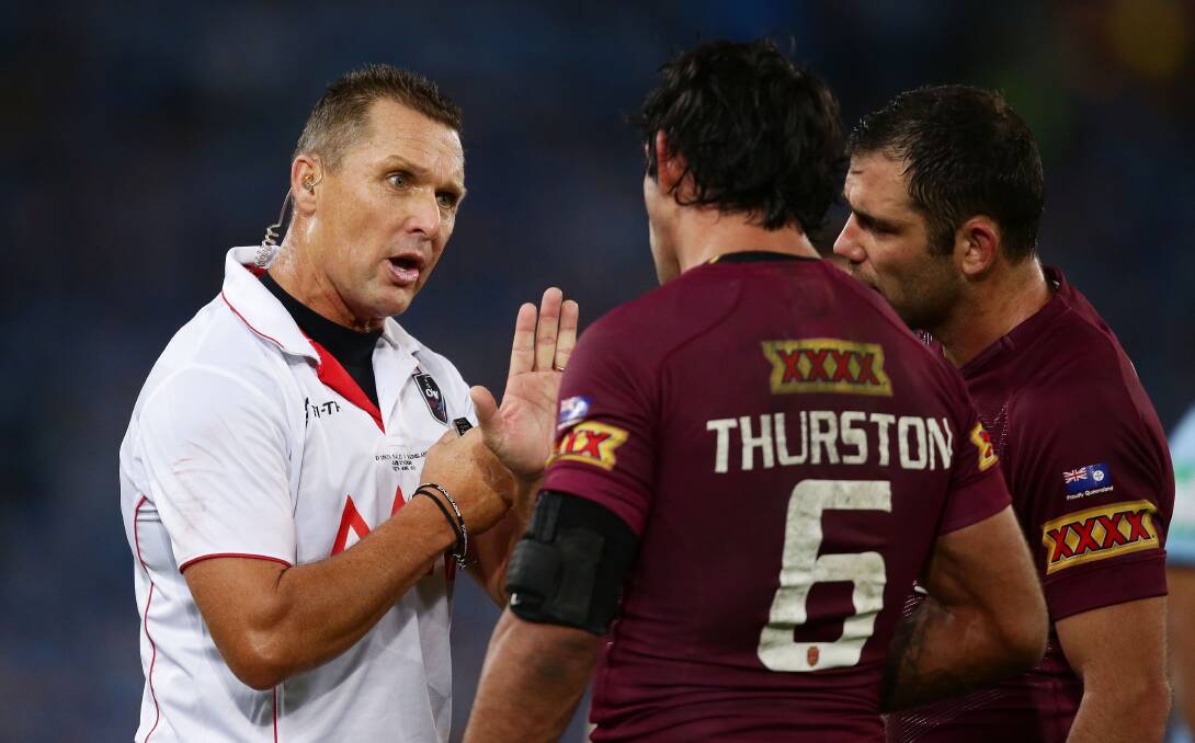 Referee Shayne Hayne speaks to Queensland's Johnathan Thurston and Cameron Smith before putting Thurston on report during game two of the State of Origin. Picture: GETTY IMAGES