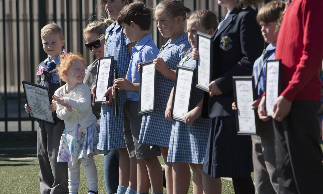 Respect: St John’s Primary School students take part in the Anzac ceremony, which began with a flypast.