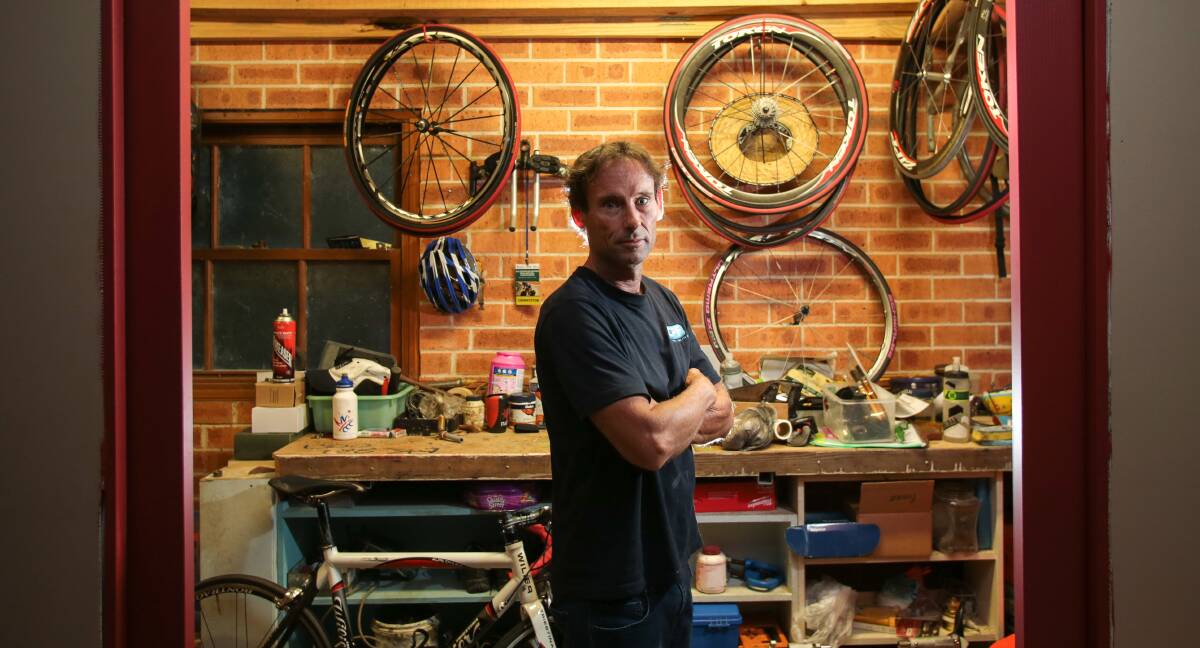 Distraught: Keith Bennett in his garage following the theft of two valuable push bikes from his home. He is offering a reward for their return. Picture: ADAM McLEAN