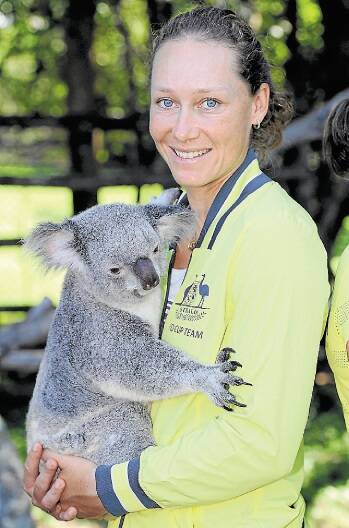 Australia's Samantha Stosur handles a koala during the official draw on Friday. Picture: GETTY IMAGES
