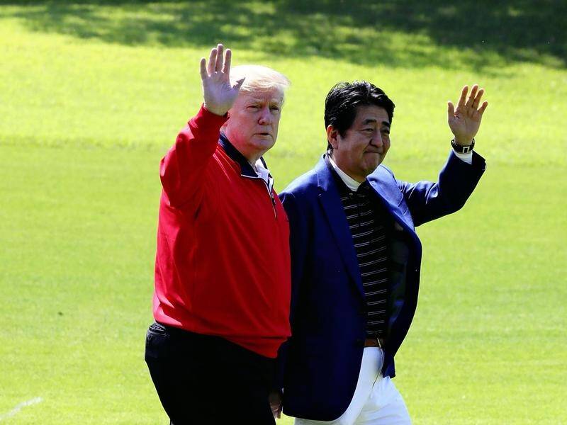 Donald Trump has played golf Japan's Prime Minister Shinzo Abe durng a state visit to Japan.