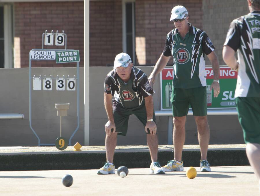 Taren Point skip Wayne Turley (left) and teammate John Green ride the fortunes of a bowl during the Sydney club's 70-53 Grade 1 grand final win over South Lismore at Dapto Citizens Bowling Club. Picture: ANDY ZAKELI
