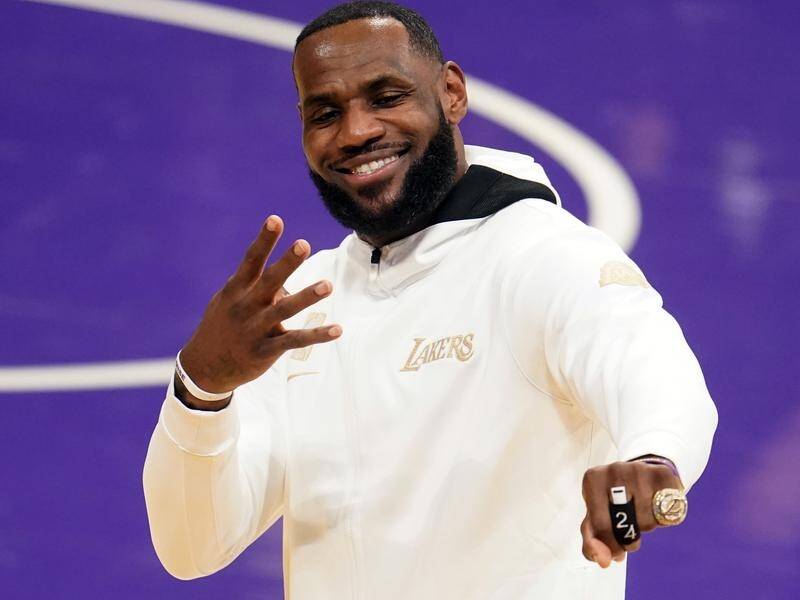 Los Angeles Lakers forward LeBron James shows off his fourth NBA championship ring.