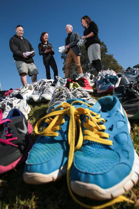 Scott Dempsey, Kathy McCarthy, Gordon Bradbery and Kylie Elliott with the shoes for charity. Picture: ADAM McLEAN