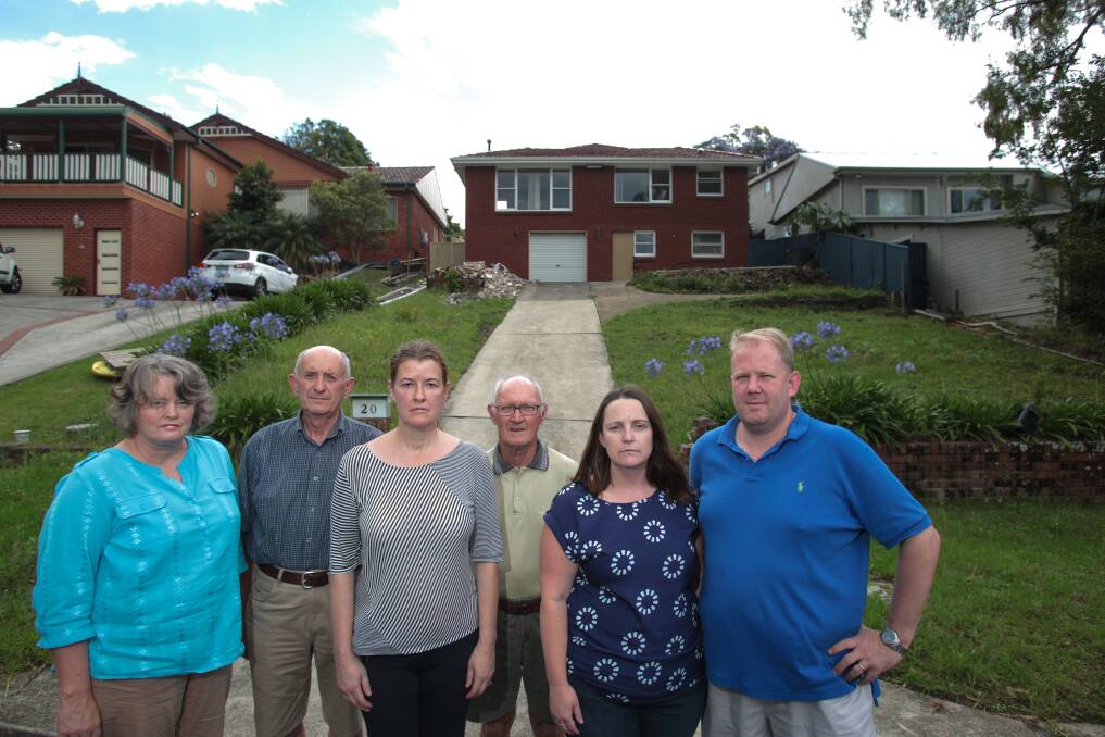 Keiraville residents Jenny Beck, Neil Gibson, Karen Wyatt, Barry Anger, Kristy and Darren Robaard say a childcare centre planned for their street should not go ahead. Picture: ADAM McLEAN