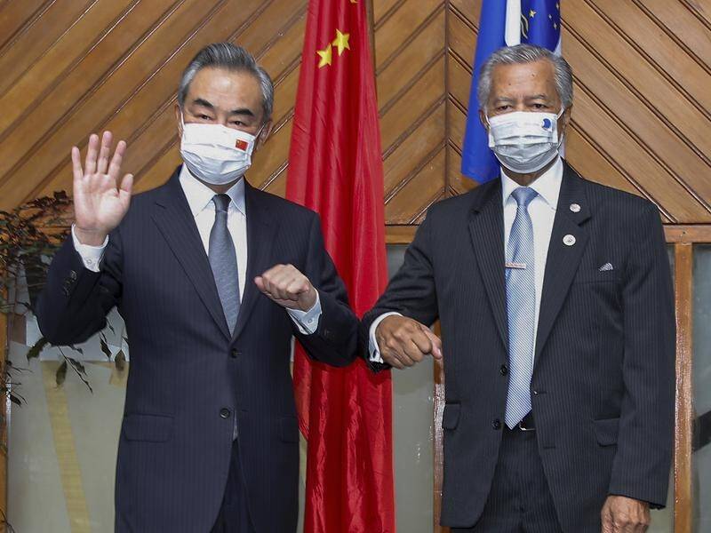 Chinese Foreign Minister Wang Yi (left) has met with his counterparts as the Pacific Islands Forum.