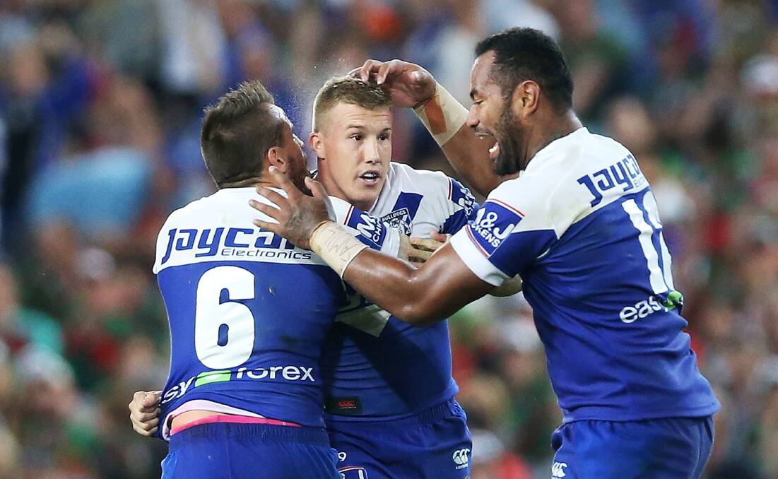 Trent Hodkinson is mobbed by Bulldogs teammates Josh Reynolds and Tony Williams. Picture: GETTY IMAGES