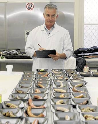 Meat and Livestock Australia judge checks out the entries in the Sausage King competition. Picture: ANDY ZAKELI