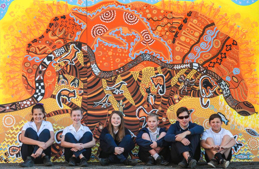 Figtree High School students Holly McDonald, Zoe Williams, Hannah Bryant, Patrick Denham, Ross Kyriazis and Kade Hutchings helped paint the mural. Picture: ADAM McLEAN