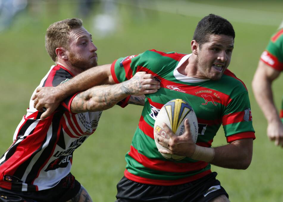 Mark Asquith breaks a tackle before scoring for Jamberoo against Kiama at Kevin Walsh Oval.
