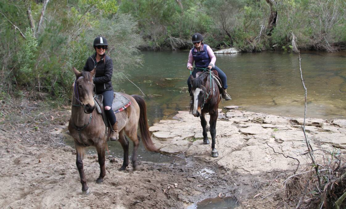 Saddle-up: Jodie Croker leads a trail ride at Darkes Forest Riding Ranch. Fine weather has meant it's been a busy time at the ranch. Picture: GREG ELLIS