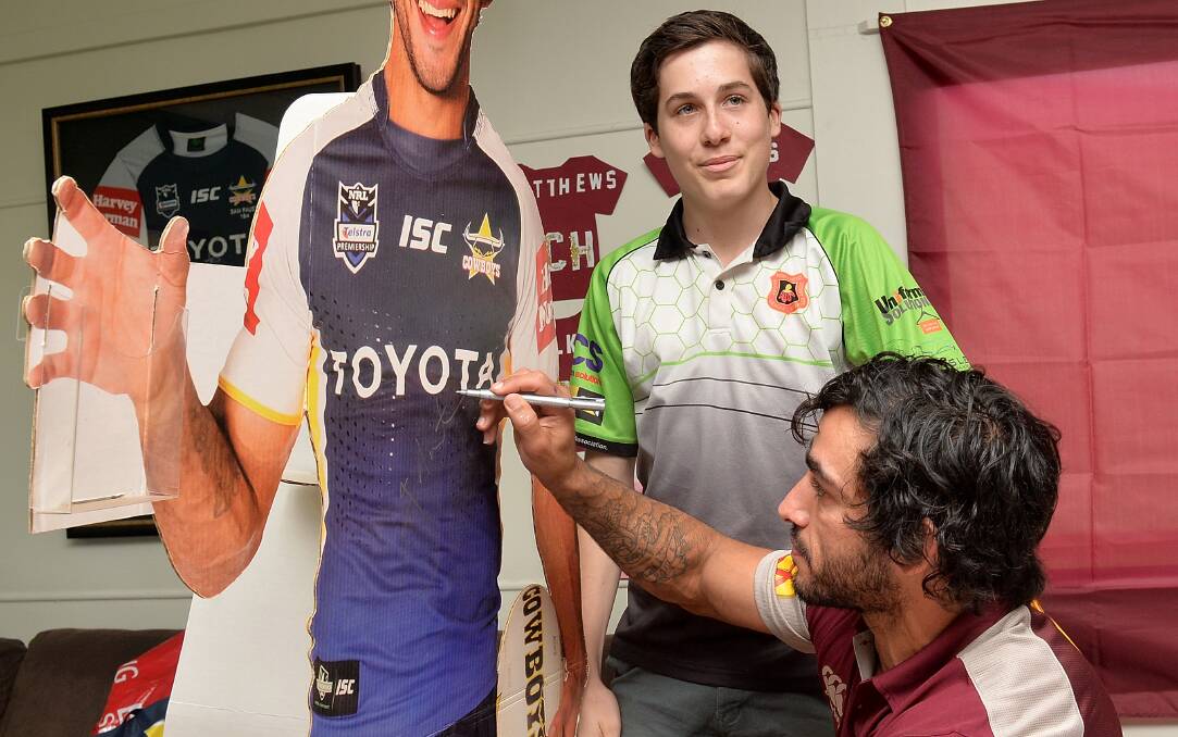 Johnathan Thurston signs autographs during the Queensland State of Origin fan day. Picture: GETTY IMAGES