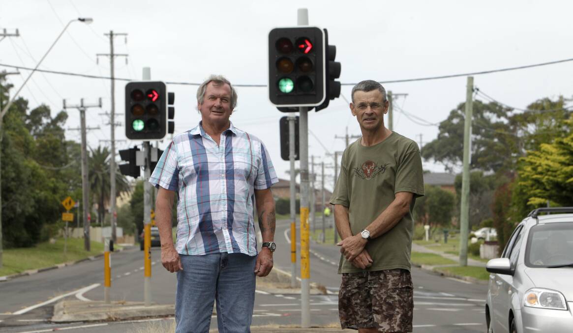 Uncertain future: Kiama councillor Mark Way, left, with Kiama Downs resident Wayne Hogan at the traffic lights in Kiama Downs, which are under review by the Kiama traffic committee. Picture: ANDY ZAKELI