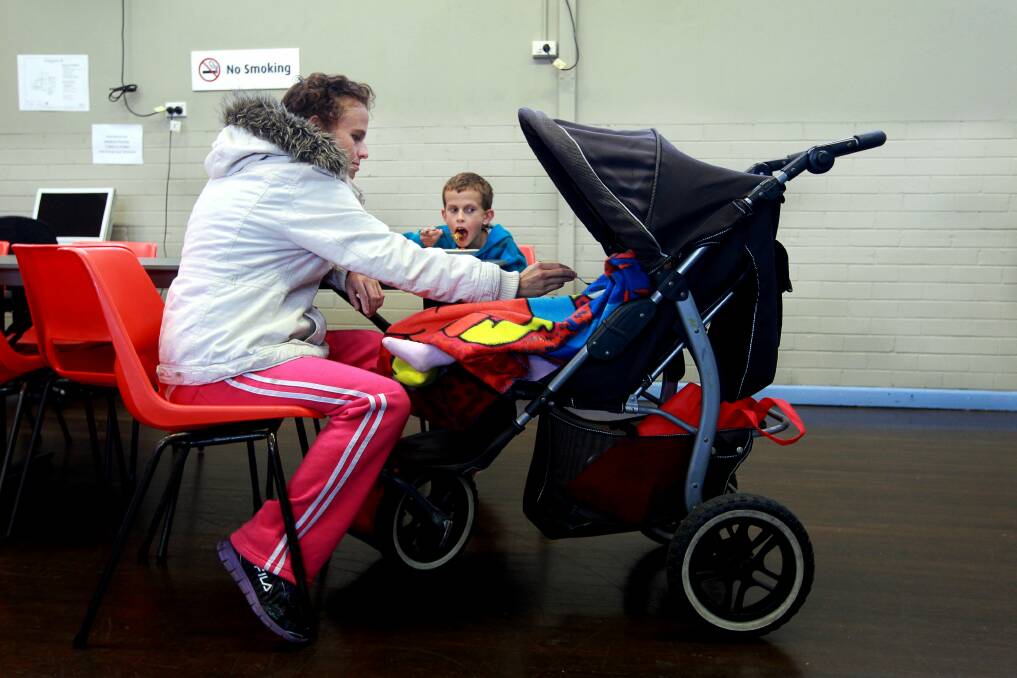 Filling a gap: Berkeley mother Kristy feeds two of her children at the community centre. Picture: SYLVIA LIBER