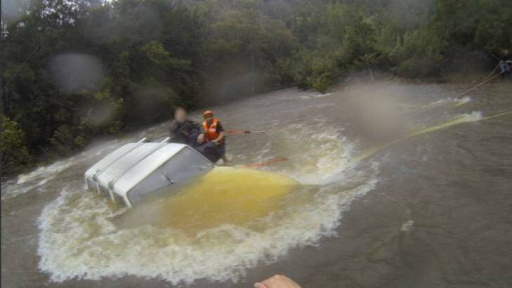 Three people plucked from their car after becoming stuck in floodwaters at Moruya. Photo: Supplied
