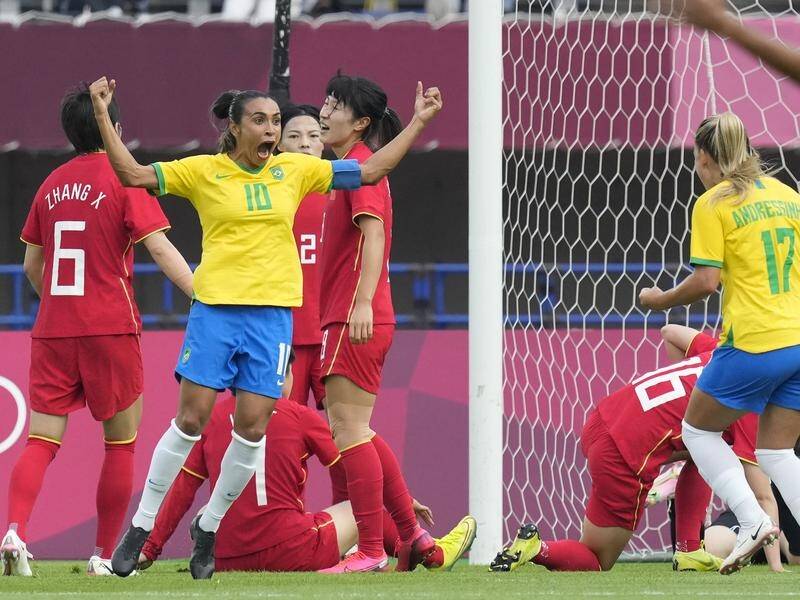 Marta scored twice in Brazil's 5-0 win over China, becoming the first player to net at five Games.