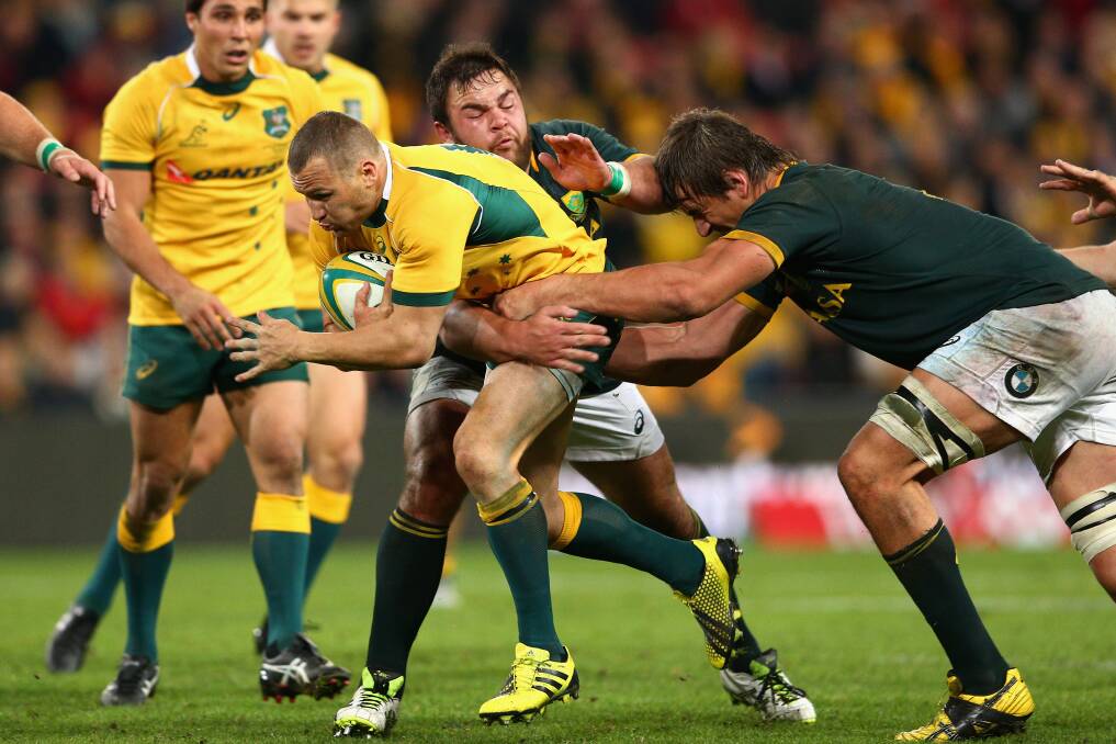 Wallabies inside centre Matt Giteau in his first Test in four years gets some attention from the Springboks. Picture: GETTY IMAGES