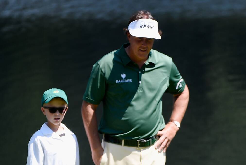 Phil Mickelson with Oliver Mackay during the traditional pre-Masters par-three tournament at Augusta National. Picture: GETTY IMAGES