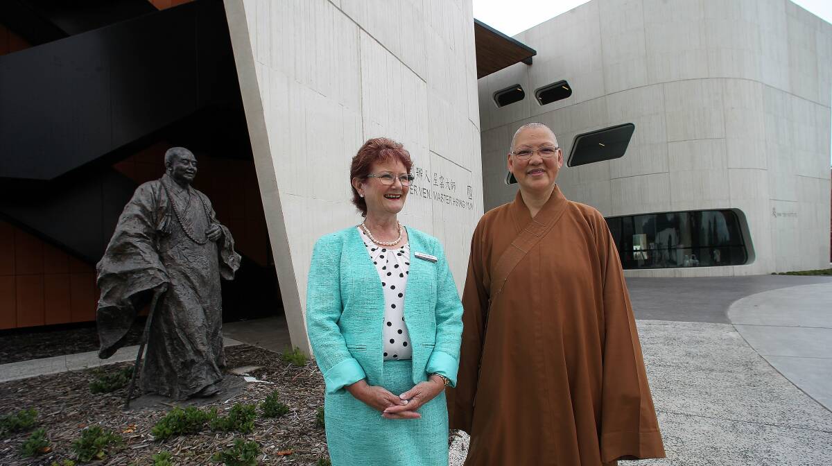 Anticipation: Nan Tien representatives Dr Leigh Wilson and Venerable Miaoyouin in front of the new campus at the Nan Tien Institute. Picture: GREG TOTMAN