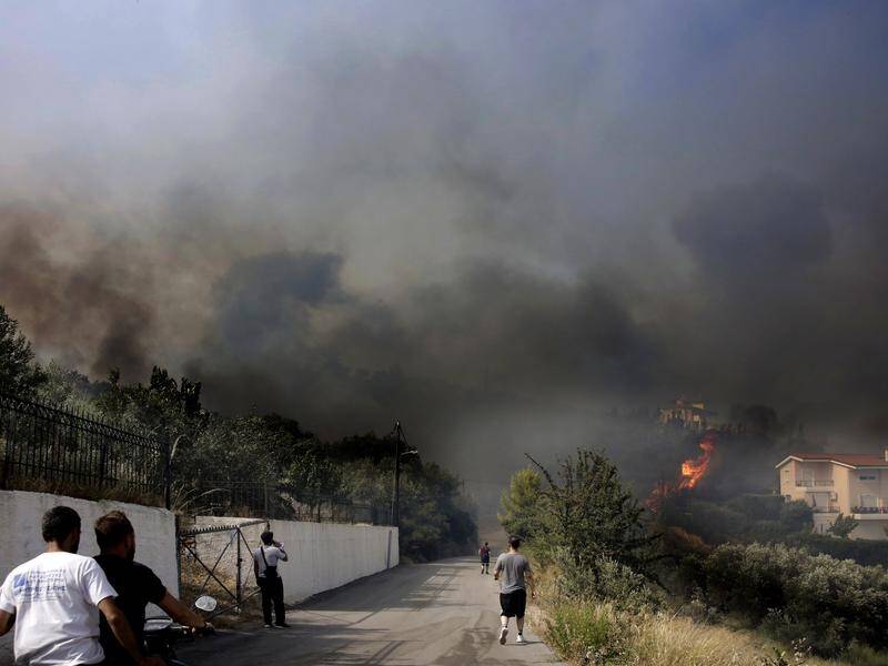 Five people have died in Greece's wildfires, which continue to be fuelled by soaring temperatures. (EPA)