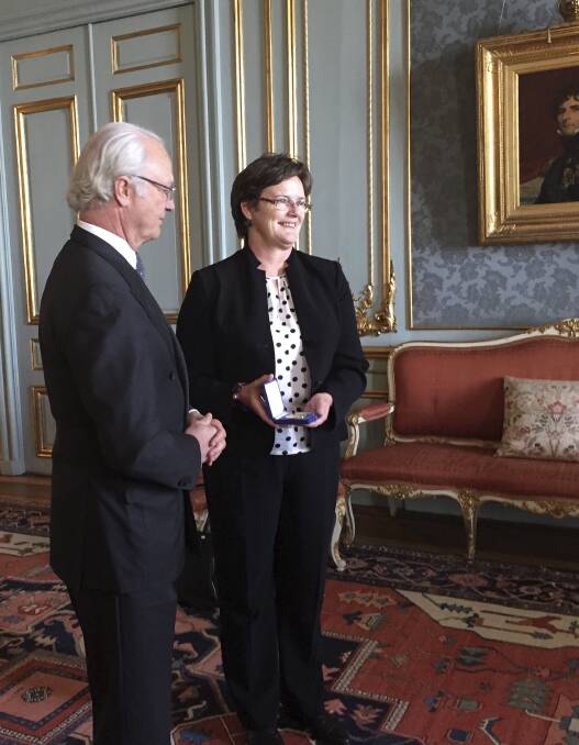 Thrilled: University of Wollongong Professor Lesley Head receives the Vega Medal from King Carl XVI Gustav of Sweden for services to human geography in relation to climate research. Picture: MADELEINE BON