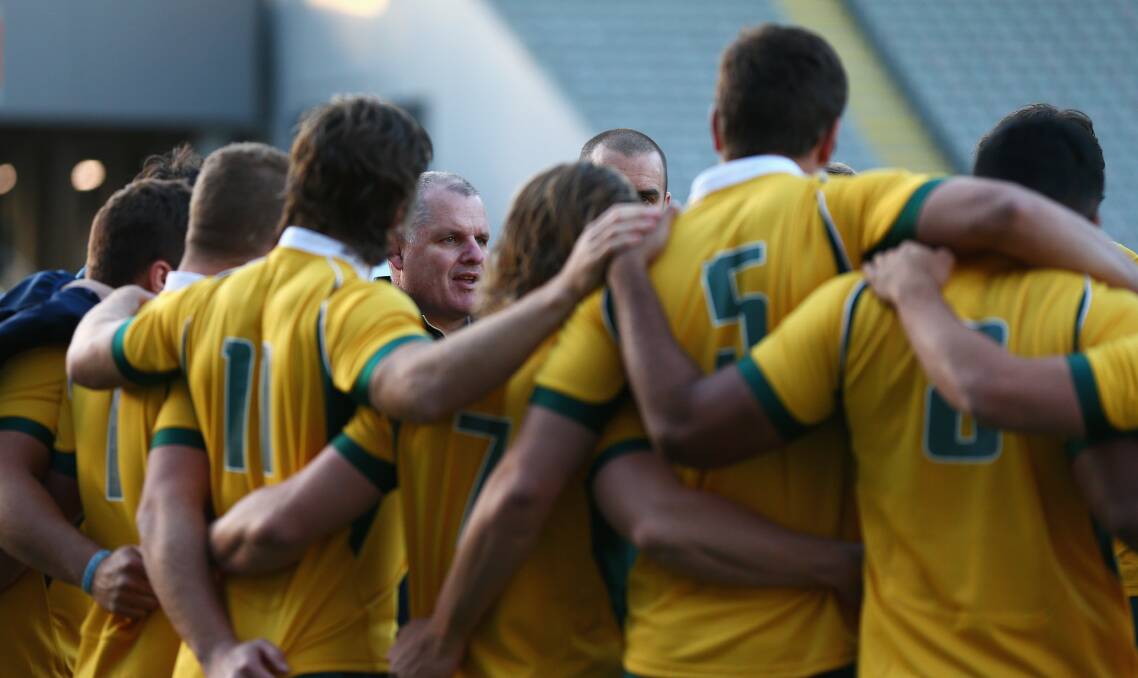 Ewen McKenzie talks to his players at Eden Park on Friday. The Wallabies coach is backing his players to lift their game. Picture: GETTY IMAGES