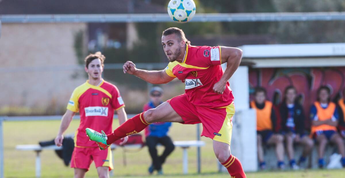 Wollongong United's Nathan Jagelman gets airborne against Woonona at Ocean Park on Saturday. Picture: ADAM McLEAN