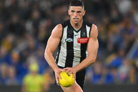 Collingwood champion Scott Pendlebury will miss the next month because of a bicep injury. (Morgan Hancock/AAP PHOTOS)