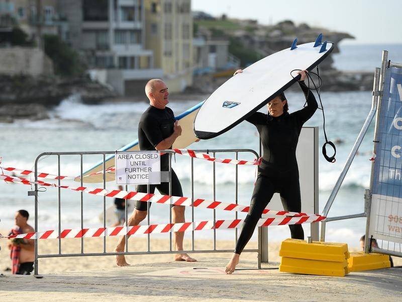 Several backpackers around Bondi have been diagnosed with Covid-19, as councils close beaches.