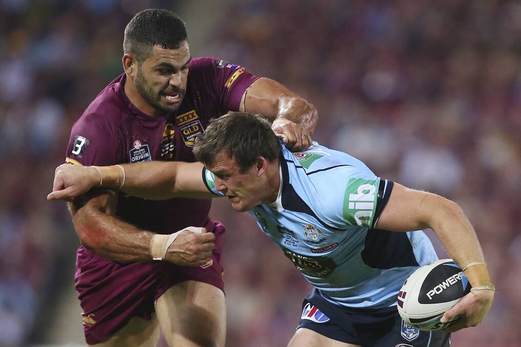Josh Morris is tackled by Greg Inglis in game one of the State of Origin series at Suncorp Stadium on May 28. Picture: GETTY IMAGES