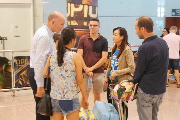 Family and friends of Suria Intan, including Emi Intan, are met by consular officials at Barcelona airport on Saturday. Photo: Nick Miller
