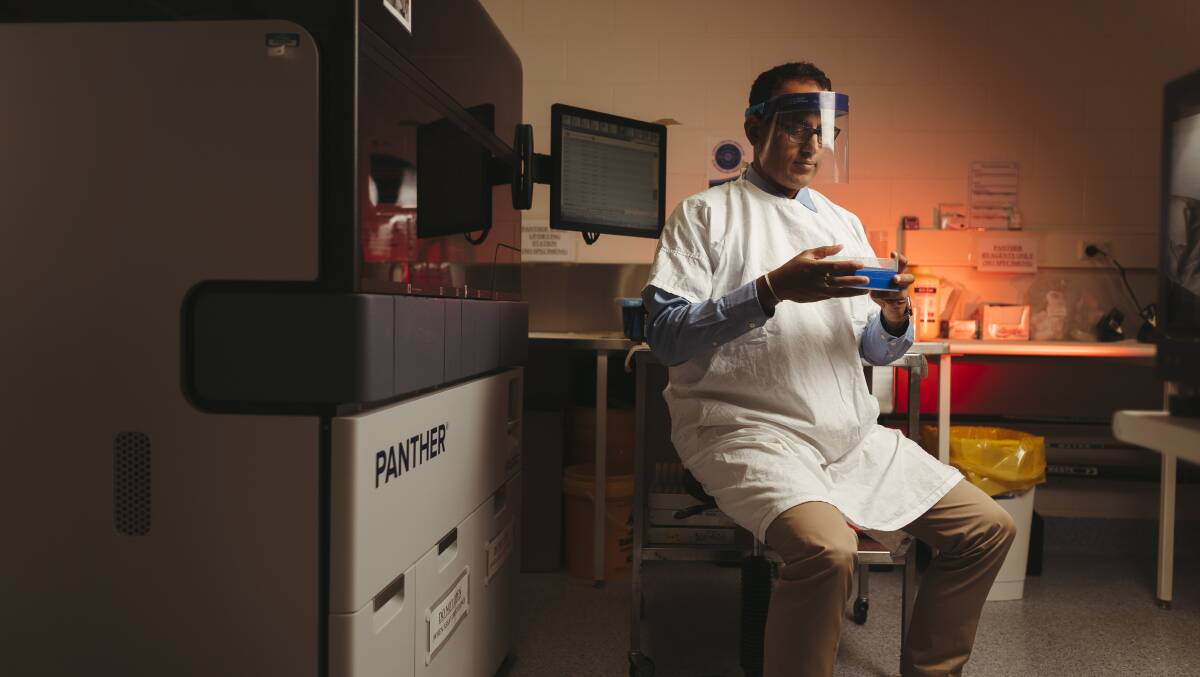 Dr Sanjaya Senanayake. The Panther machine is used to analyse COVID tests. Picture: Dion Georgopoulos